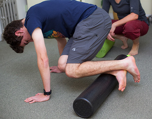 Teen client learning how to use a foam roller for self-care